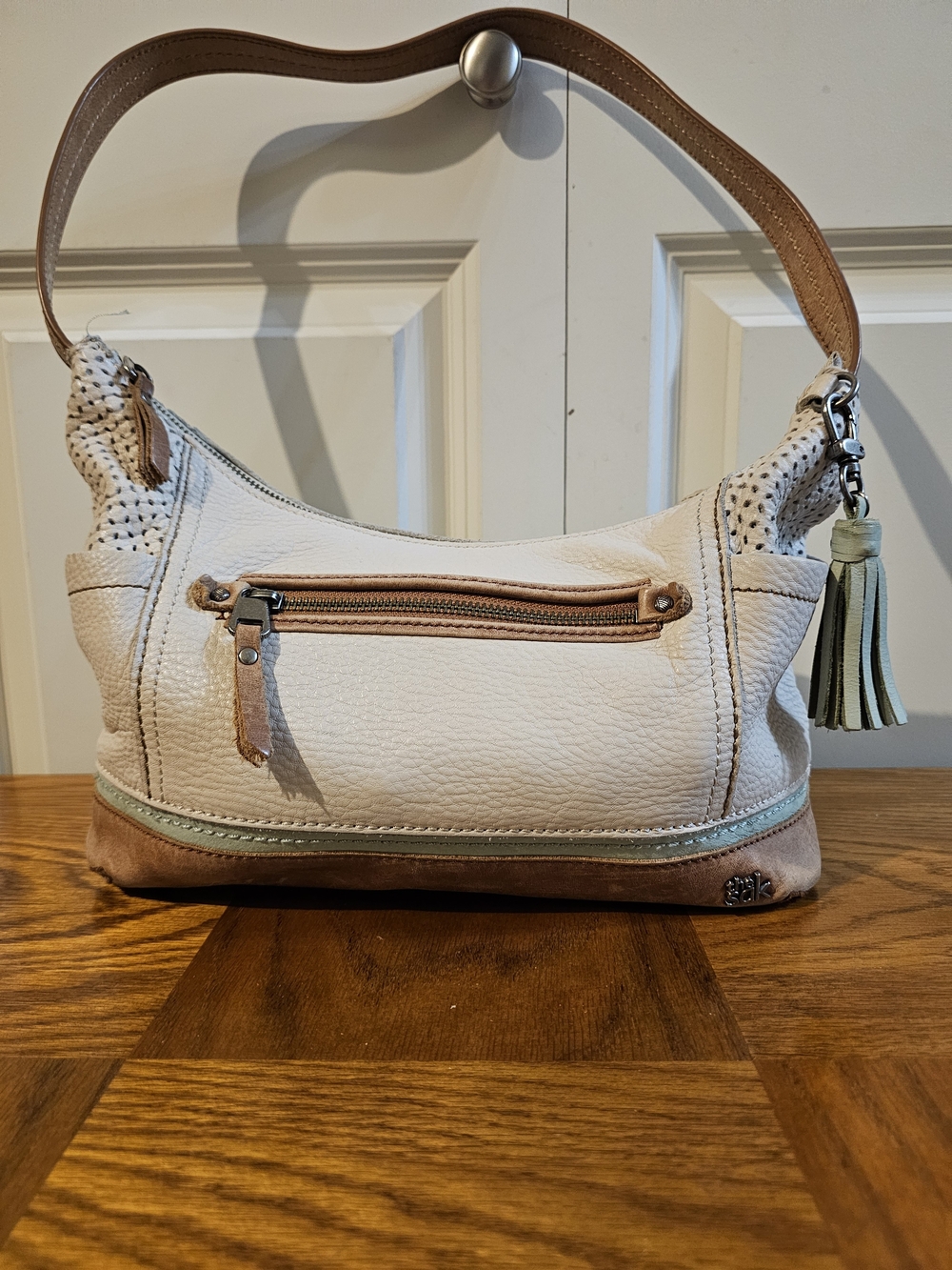 The SAK Cream Leather Shoulder Bag with Tassel Accent